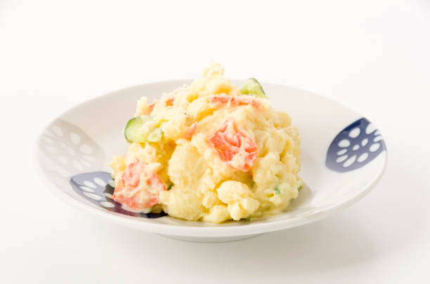 potato salad in white plate on white background