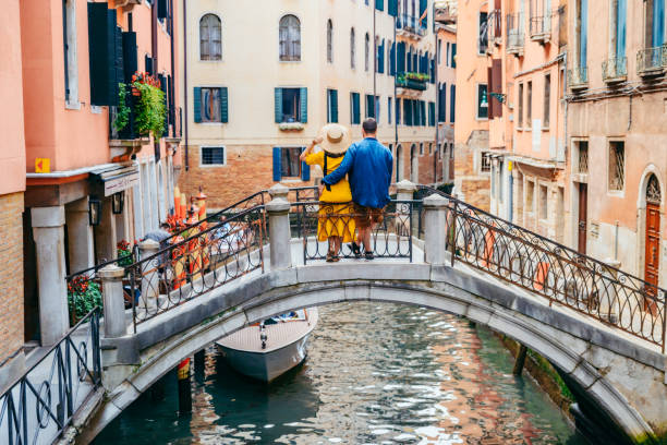 istock couple standing on the bridge crossing venice canals 1208357722