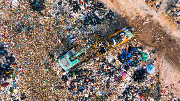 istock Ecosystem and healthy environment concepts and background, Garbage pile in trash dump or landfill, Aerial view garbage trucks unload garbage to a landfill, global warming. 1208359076