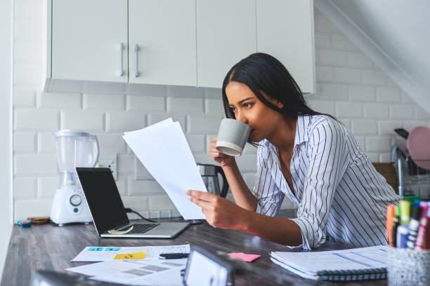 istock Coffee in one hand, finances in the other 1208359207