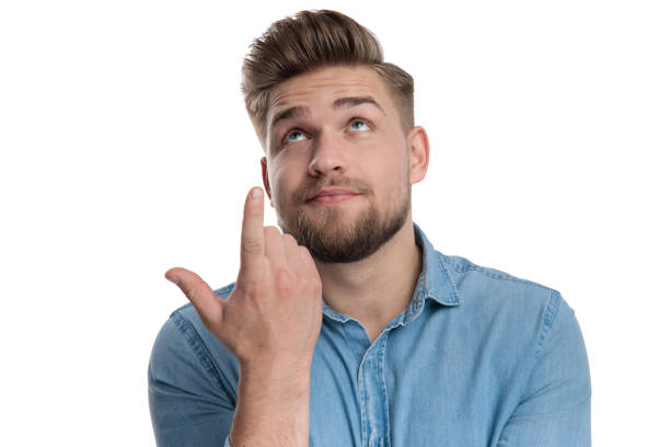 istock Confident casual man pointing upward while wearing shirt 1208361435