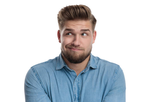 istock Wondering casual man looking away unsure 1208361480