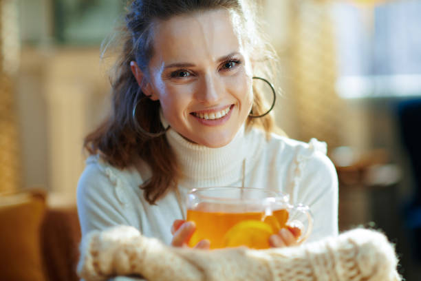 istock happy trendy woman with sweaters and tea 1208362488