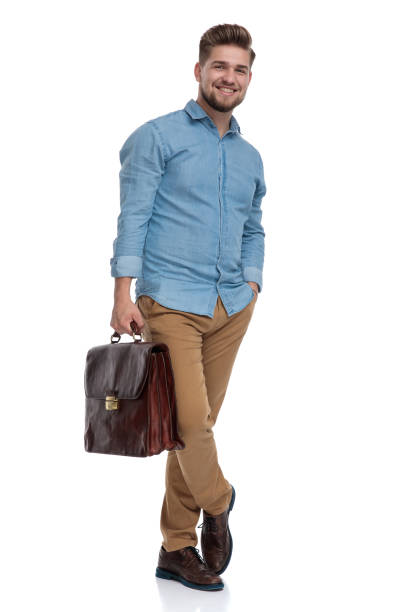 istock Handsome casual laughing while holding briefcase and hand in pocket 1208362500