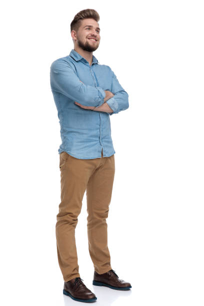 istock Hopeful casual man looking away with his hands crossed 1208363087