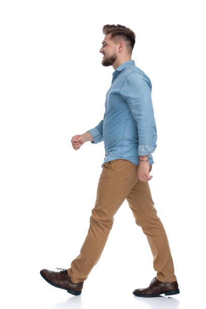 istock Side view of a happy casual man walking 1208363278