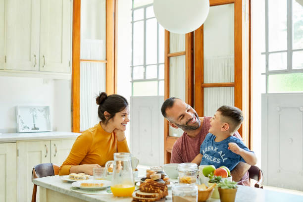 istock Happy family having breakfast together at home 1208363361