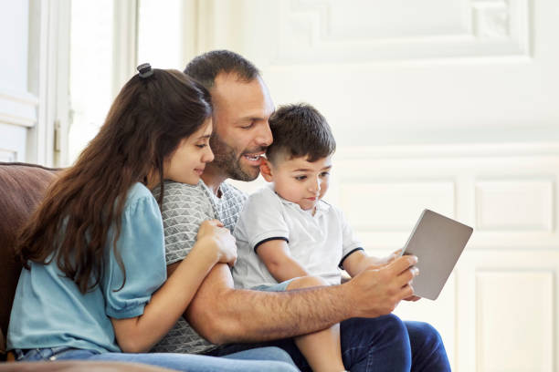 istock Family using digital tablet at home 1208363427