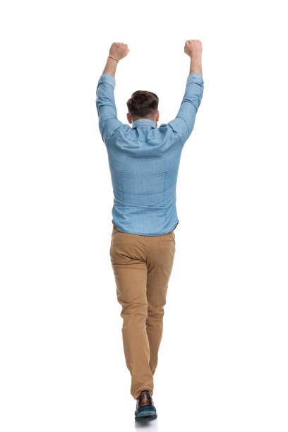 istock Rear view of a celebrating casual man walking 1208364661