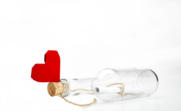 istock Message in a bottle with red heart shape 1208364839