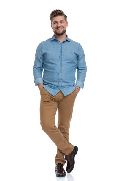 istock Happy casual man holding both hands in his pockets 1208364876