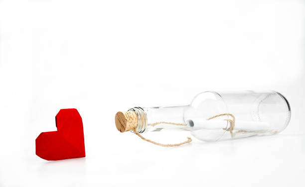 istock Message in a bottle with red heart shape 1208364882