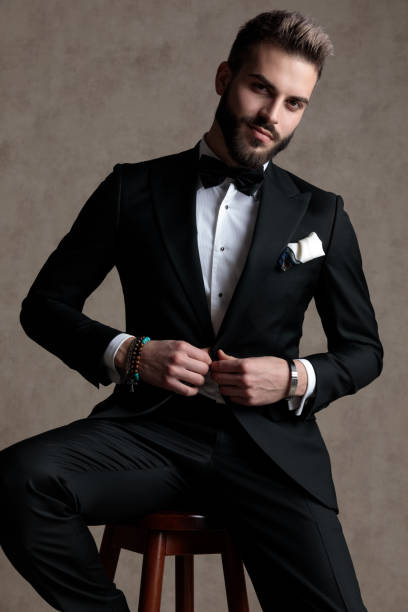 istock Confident groom smiling and unbuttoning his jacket 1208366927