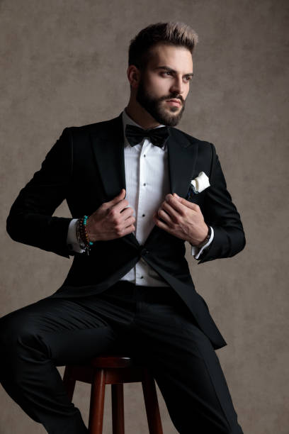 istock Confident groom adjusting his jacket and looking away 1208367028