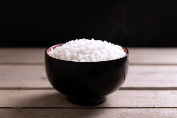 istock White rice in black bowl on wooden background 1208367386