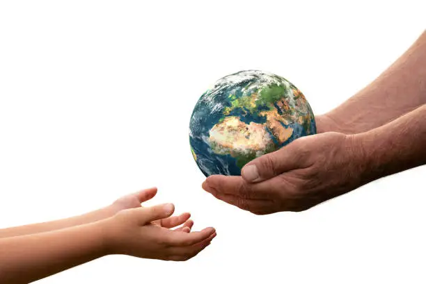 Close up of senior hands giving small planet earth to a child isolated on white background. Element of this image furnished by NASA ( https://earthobservatory.nasa.gov/blogs/elegantfigures/2011/10/06/crafting-the-blue-marble/ )