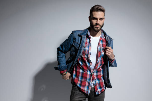 istock Serious young model frowning and fixing his jacket 1208368234