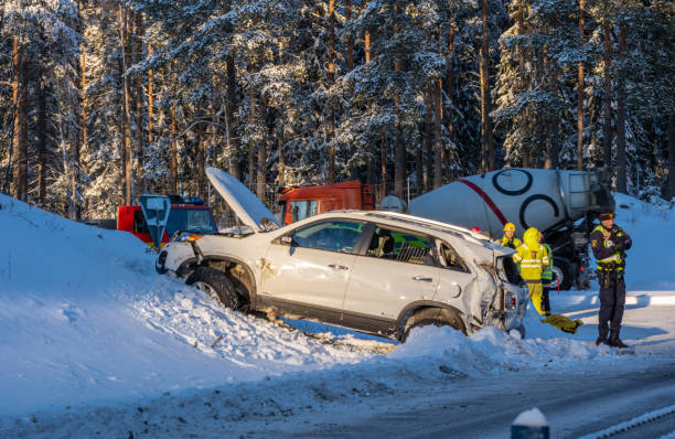 Crashed car in the ditch of a winter road in Sweden stock photo