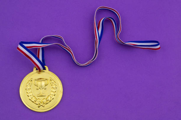 istock Golden medal on purple background 1208371034