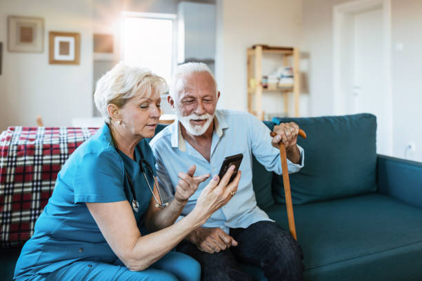 istock Mature nurse spending time with happy elder patient in nursing home 1208371084