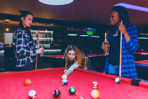 istock Group of friends play billiards 1208371133