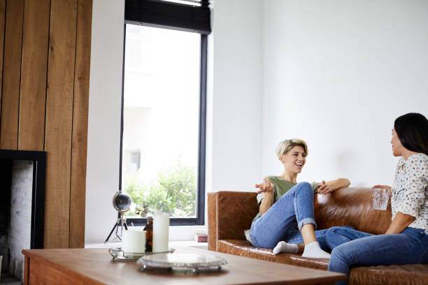 istock Happy woman talking with girlfriend at home 1208371243