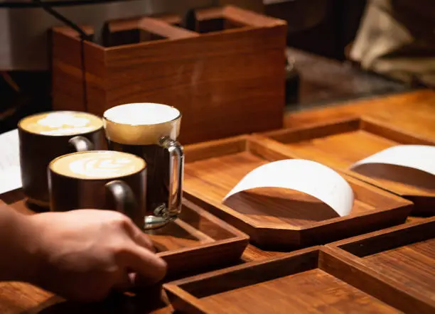 Photo of The unspecific barista serving the coffe to their customer at the  Shanghai Starbucks Roastery is the world's largest Starbuck.