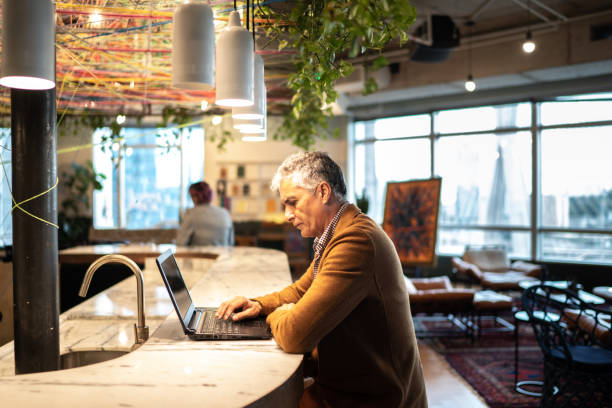 istock Serious businessman working with laptop at coworking 1208372282