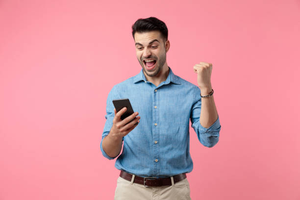 casual young guy shouting and looking at the phone