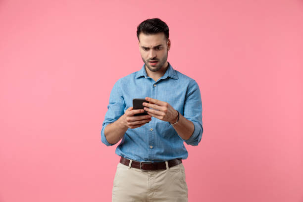 istock shocked young guy holding phone and reading news 1208372546