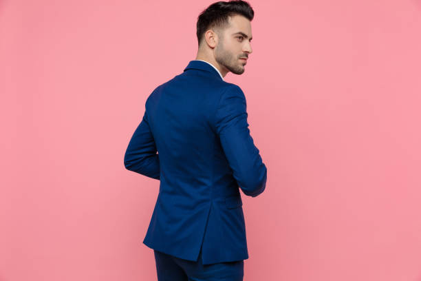 rear view of a charming businessman wearing blue suit - sensuality horizontal indoors studio shot imagens e fotografias de stock