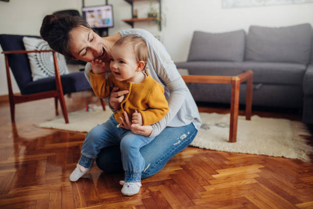 istock Young mother having fun with her child at home. 1208373163