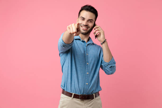 istock happy young casual guy talking on the phone 1208374309