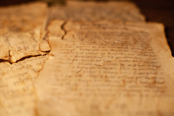 istock Magic scrolls on a wooden table with letters and drawings. 1208374375