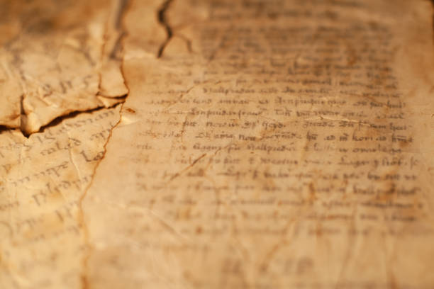 istock Magic scrolls on a wooden table with letters and drawings. 1208374391