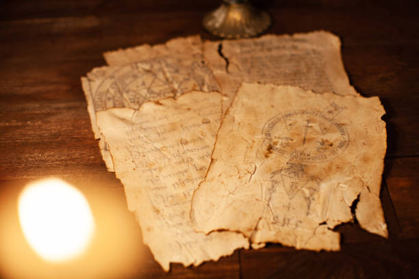 istock Magic scrolls on a wooden table with letters and drawings. 1208374419