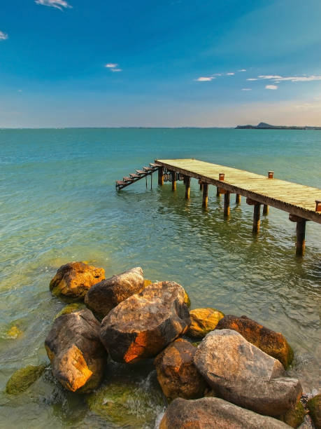 HDR photo showing lonely pier at beautiful Garda lake, Italy.