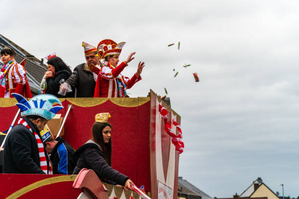 Children's Princely Couple of Waldorf throwing candy from a parade float at the carnival parade Bornheim, North Rhine-Westphalia, Germany - February 22, 2020: Children's Princely Couple of Waldorf throwing candy from a parade float at the carnival parade triumvirate stock pictures, royalty-free photos & images