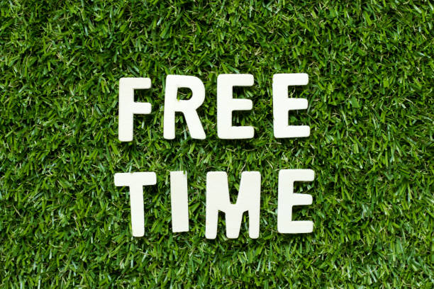 istock Alphabet letter in word free time on artificial green grass background 1208383939