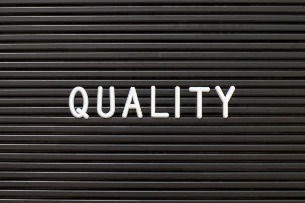 istock Black color felt letter board with white alphabet in word quality background 1208384571