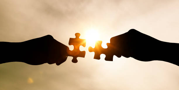 istock Put together two jigsaw puzzle pieces 1208385116