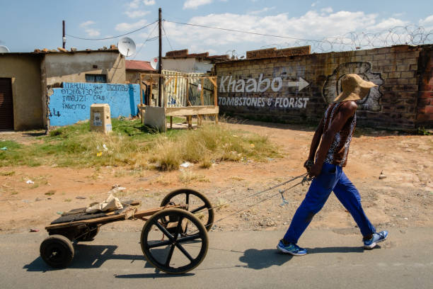 Johannesburg, South Africa - March 29, 2017: A local man pulls a cart along the streets of Johannesburg’s Soweto township, the largest township in South Africa.
