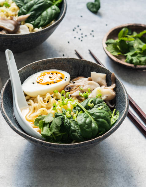 istock Vegetarian Miso Ramen with Mushrooms, raw Spinach and boiled Egg in blue bowl 1208387466