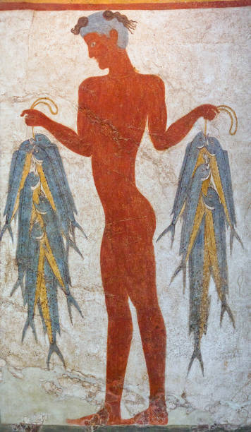 Wall painting of a young fisherman holding string of fish Thera, Santorini island, Cyclades, Greece - March 16, 2018: Wall painting fresco of a young fisherman holding string of fish in Akrotiri Minoan Bronze Age settlement on the volcanic Greek island of Santorini. The Akrotiri site associated with the Minoan civilization. Akrotiri has been excavated since 1967. minoan photos stock pictures, royalty-free photos & images