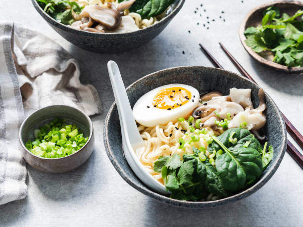 istock Vegetarian Miso Ramen with Mushrooms, raw Spinach and boiled Egg in blue bowl 1208387536