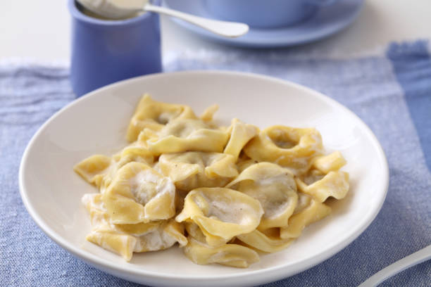 istock Ravioli dumplings under cream sauce 1208390152