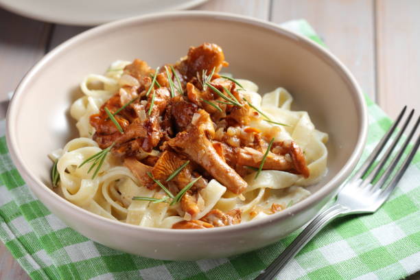istock Fettuccine pasta with Chanterelle mushrooms and rosemary on a rustic table 1208390338