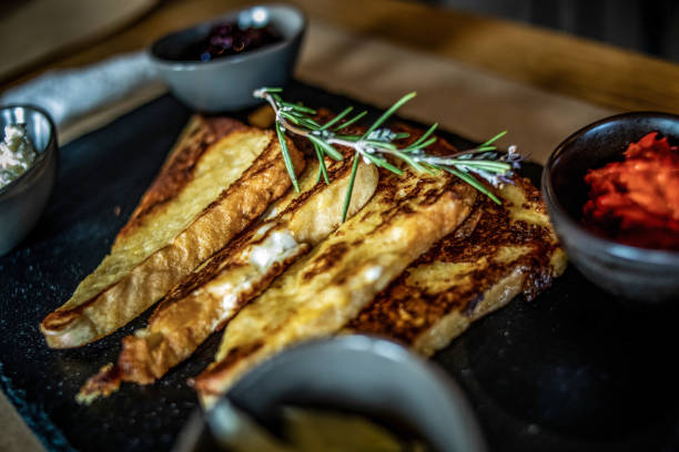 French toasts French toasts on a wooden plate, served at a restaurant french toast bacon bread butter stock pictures, royalty-free photos & images