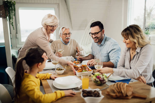 istock Happy multi-generation family enjoying in lunch at home. 1208390862