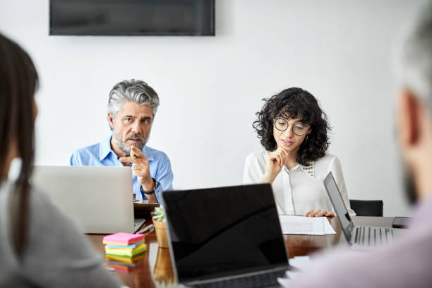 istock Confident businessman discussing with colleagues 1208391017